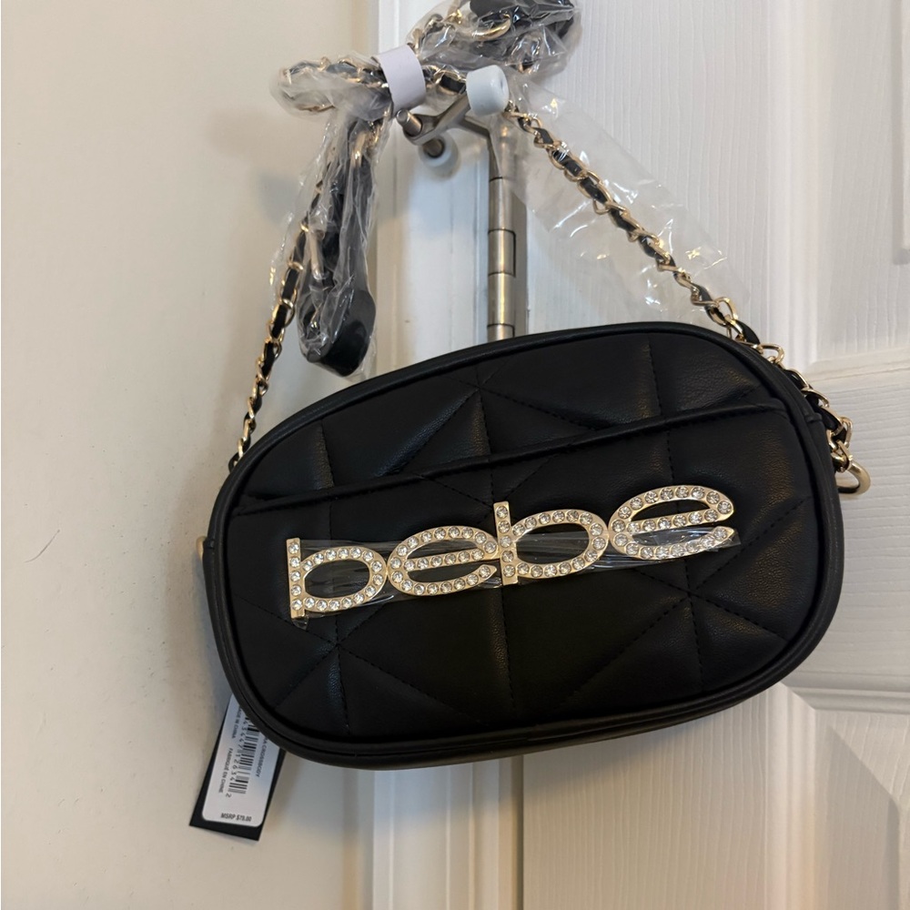 Brand new cross body quilted black purse with gold trim. Has tags attached.